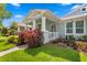 Landscaped front yard of a beautiful home, featuring vibrant red foliage and a charming walkway at 9503 W. Park Village Dr, Tampa, FL 33626