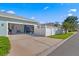 Exterior view of the two car garage with an open door and concrete driveway at 9503 W. Park Village Dr, Tampa, FL 33626