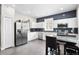 Kitchen with white cabinets, stainless steel appliances, and a modern blue backsplash at 9503 W. Park Village Dr, Tampa, FL 33626