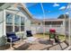 Relaxing outdoor lanai area with seating, grill, and screen enclosure at 9503 W. Park Village Dr, Tampa, FL 33626