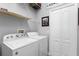 Laundry room with shelving and washer and dryer at 9503 W. Park Village Dr, Tampa, FL 33626