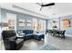 Bright and airy living room featuring a plush blue sofa, stylish decor, and an open layout to the dining area at 9503 W. Park Village Dr, Tampa, FL 33626