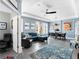 Spacious living room with blue walls, modern furniture, and abundant natural light, creating a welcoming atmosphere at 9503 W. Park Village Dr, Tampa, FL 33626