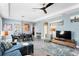 Spacious living room features blue walls, stylish decor, a modern ceiling fan, and gray tile floors at 9503 W. Park Village Dr, Tampa, FL 33626