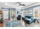 Comfortable living area with a blue sectional, contemporary artwork, and a seamless flow to other living spaces at 9503 W. Park Village Dr, Tampa, FL 33626