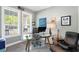 Bright office with large windows, glass top desk, and comfortable seating at 9503 W. Park Village Dr, Tampa, FL 33626