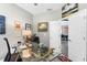 Office with glass top desk, neutral paint, and view to dining area at 9503 W. Park Village Dr, Tampa, FL 33626