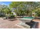 Community recreation area with ping pong tables, benches, and shady trees for outdoor enjoyment at 9503 W. Park Village Dr, Tampa, FL 33626