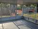 View of the backyard from a screened porch, offering a seamless indoor-outdoor experience at 1408 Oleander Dr, Tarpon Springs, FL 34689