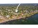 Aerial view of a home, pointing to the property with waterfront access and lush landscaping at 1039 Union St, Clearwater, FL 33755