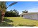 Expansive backyard featuring a well-maintained lawn, mature trees, and a classic fountain at 1039 Union St, Clearwater, FL 33755