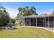 Charming backyard with a screened lanai, a three-tiered fountain, and lush landscaping at 1039 Union St, Clearwater, FL 33755