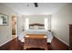 Primary bedroom features hardwood floors, a calming color scheme, and ensuite bathroom at 1039 Union St, Clearwater, FL 33755