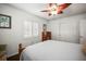 Serene bedroom showcasing a ceiling fan, plantation shutters, and natural light at 1039 Union St, Clearwater, FL 33755