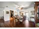 Dining area with hardwood floors, ceiling fan, dining room set, and access to living room and outdoor lanai at 1039 Union St, Clearwater, FL 33755