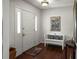 Entryway featuring a white front door, a bench with decorative pillows, hardwood floors and recessed lighting at 1039 Union St, Clearwater, FL 33755