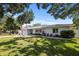 Traditional single-story home featuring a lush lawn, shade trees, and a welcoming front facade at 1039 Union St, Clearwater, FL 33755