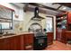 Contemporary kitchen with stainless steel appliances, wood cabinets, granite countertops, and access to a dining area at 1039 Union St, Clearwater, FL 33755