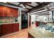 Stylish kitchen with stainless steel appliances, wood cabinets, granite countertops, and tiled backsplash at 1039 Union St, Clearwater, FL 33755