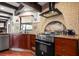 Modern kitchen boasting a stainless steel range hood, gas range, wood cabinets, and a tiled backsplash at 1039 Union St, Clearwater, FL 33755