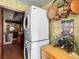 Convenient laundry room with a stacked washer and dryer, storage, and rustic decor in the hall at 1039 Union St, Clearwater, FL 33755