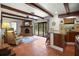 Cozy interior featuring a fireplace, wet bar, terra cotta flooring, wood beams, and large windows to the back yard at 1039 Union St, Clearwater, FL 33755