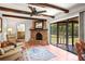Cozy living room featuring a brick fireplace, tiled floors, and screened-in porch access at 1039 Union St, Clearwater, FL 33755