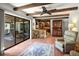 Open living space with beamed ceiling, terra cotta tile flooring and access to an outdoor patio and kitchen at 1039 Union St, Clearwater, FL 33755