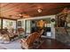 Relaxing patio with brick flooring, ceiling fan and wood ceiling, stone accent wall, and a glimpse into the dining room at 1039 Union St, Clearwater, FL 33755