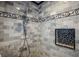 Custom tiled shower featuring decorative tile and built in niche at 1039 Union St, Clearwater, FL 33755
