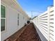 A long side yard with wood chips, a white fence, and access to a patio at 1039 Union St, Clearwater, FL 33755