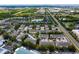 Community aerial view showcasing townhomes around a central pond, landscaping, parking and surrounding neighborhoods at 1051 Andrew Aviles Cir, Tampa, FL 33619