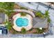 Aerial view of community pool with lounge seating, trees, and nearby parking at 1051 Andrew Aviles Cir, Tampa, FL 33619