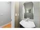 Well-lit half bathroom featuring a stylish vanity with modern sink and an arched mirror at 1051 Andrew Aviles Cir, Tampa, FL 33619