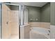 This bathroom features a tiled shower with glass doors and a soaking tub at 1051 Andrew Aviles Cir, Tampa, FL 33619