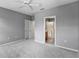 Spacious bedroom with neutral gray tones, carpet and ensuite bathroom at 1051 Andrew Aviles Cir, Tampa, FL 33619