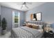 Cozy bedroom with a bed, window, art, and ceiling fan at 1051 Andrew Aviles Cir, Tampa, FL 33619
