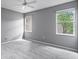 Serene bedroom showcasing neutral tones, plush carpeting, and two large windows for ample sunlight at 1051 Andrew Aviles Cir, Tampa, FL 33619