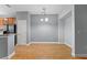 Dining area featuring wood floors, modern lighting, and an adjacent kitchen at 1051 Andrew Aviles Cir, Tampa, FL 33619