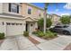 Charming townhome with a one-car garage and a well-maintained front yard with mature landscaping and green bushes at 1051 Andrew Aviles Cir, Tampa, FL 33619