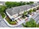 Exterior view of three tan townhomes featuring private driveways, garages, and well-maintained landscaping at 1051 Andrew Aviles Cir, Tampa, FL 33619