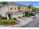 The two-story townhome features an attached garage, professional landscaping and neutral color scheme at 1051 Andrew Aviles Cir, Tampa, FL 33619