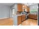 Kitchen with stainless steel appliances and wood cabinetry open to living area at 1051 Andrew Aviles Cir, Tampa, FL 33619