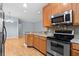 Kitchen features stainless steel appliances, wood cabinets and granite countertops at 1051 Andrew Aviles Cir, Tampa, FL 33619