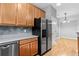 Kitchen featuring stainless steel appliances, granite counters, and wood cabinets at 1051 Andrew Aviles Cir, Tampa, FL 33619