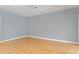 Bright, open living room featuring neutral walls, wood floors, and sliding glass doors at 1051 Andrew Aviles Cir, Tampa, FL 33619