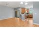 Living room area featuring wood floors and views of the kitchen area at 1051 Andrew Aviles Cir, Tampa, FL 33619