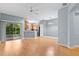 Open-concept living space with wood floors, modern lighting, and a view of the kitchen at 1051 Andrew Aviles Cir, Tampa, FL 33619