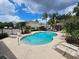 Inviting community pool with lounge chairs, palm trees, and clear blue water for recreation and relaxation at 1051 Andrew Aviles Cir, Tampa, FL 33619