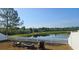 Inviting backyard with a white picket fence overlooking a serene pond, perfect for relaxation at 11227 Summer Star Dr, Riverview, FL 33579